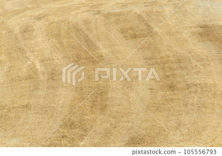 Texture from a field of golden grass mowed and the arc-shaped dark and light stripes 105556793