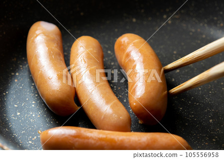 烹飪場景，將維也納香腸切入煎鍋中烘烤。 105556958