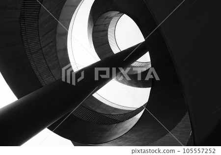An abstraction composed of spiral metal structures, columns and concrete. Black and white photo An abstraction composed of spiral metal structures, columns and concrete. Black and white photo 105557252