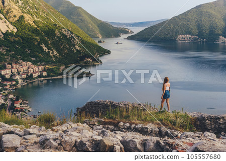Woman Traveler among Ruins of Ancient Fortress Woman Traveler among Ruins of Ancient Fortress 105557680