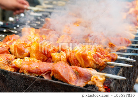 Traditional georgian mtsvadi, grill on the coals with smoke. Shashlik Traditional georgian mtsvadi, grill on the coals with smoke. Shashlik 105557830