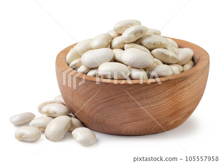 White beans in a wooden plate and scattered. Isolated White beans in a wooden plate and scattered. Isolated 105557958