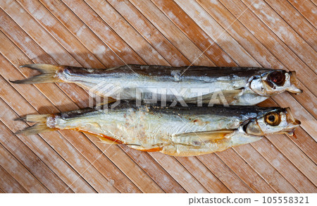 Several dried salted sabrefish on wooden background 105558321