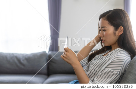 Woman holding some kind of paper sad Woman holding some kind of paper sad 105558386