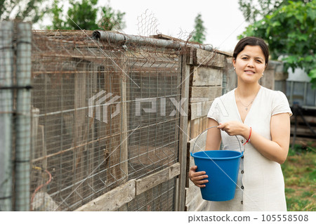 Young woman with bucket on farm. Young woman with bucket on farm. 105558508