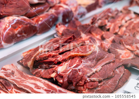 Slice of raw beef tenderloin and veal in packing tray on window refrigerator Slice of raw beef tenderloin and veal in packing tray on window refrigerator 105558545