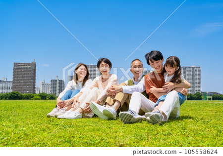 Three generations of good friends relaxing in the park 105558624
