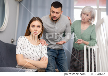 Domestic quarrel - husband and mother try to calm crying wife Domestic quarrel - husband and mother try to calm crying wife 105558664