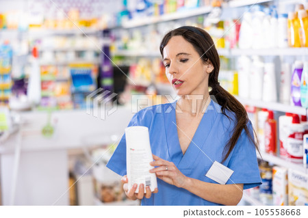 Portrait of female druggist advertising skin or hair care product Portrait of female druggist advertising skin or hair care product 105558668