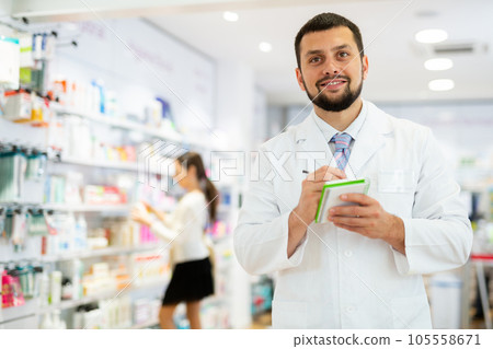 Portrait of male pharmacist working in drugstore 105558671
