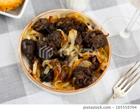 Morcilla con cebolla - traditional Spanish sausage from blood closeup Morcilla con cebolla - traditional Spanish sausage from blood closeup 105558704