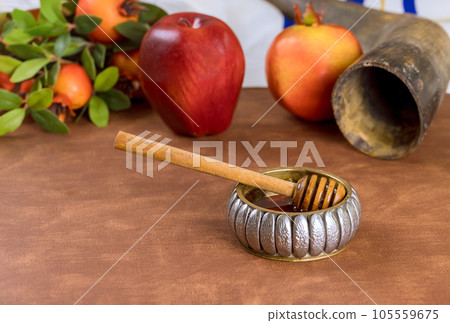 One of iconic symbols Rosh Hashanah is dipping apples in honey, symbolizing hopes for sweet fruitful year ahead. 105559675