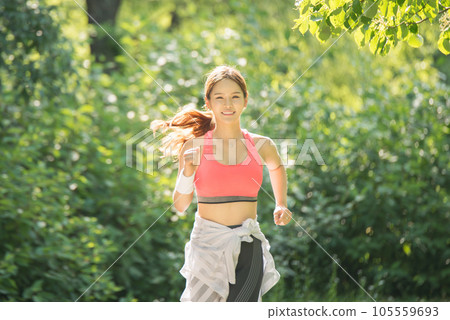 beautiful woman running in the park 105559693