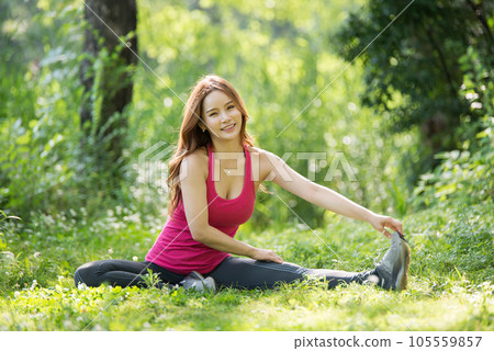 young woman doing yoga in park 105559857