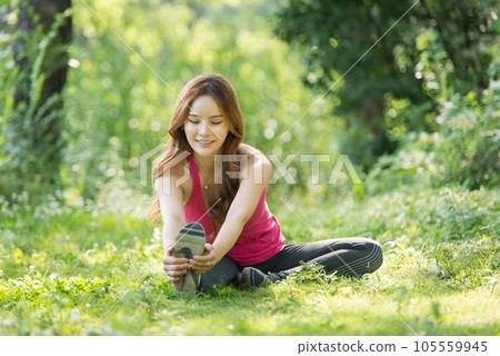 young woman doing yoga in park young woman doing yoga in park 105559945