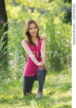 young woman doing yoga in the park 105560165