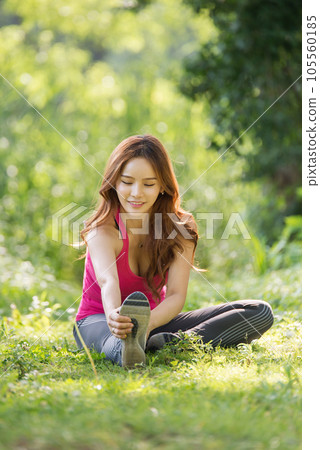 young woman doing yoga in the park 105560185