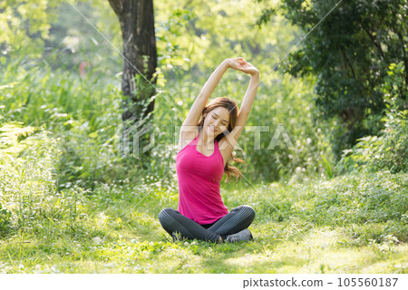 young woman doing yoga in the park 105560187