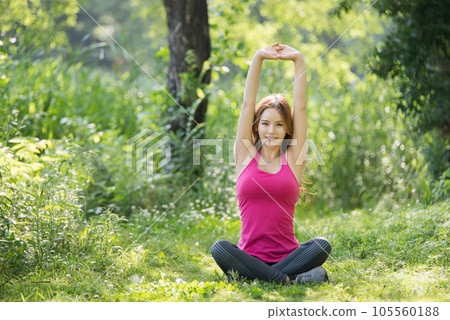 young woman doing yoga in the park young woman doing yoga in the park 105560188
