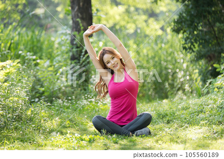 young woman doing yoga in the park 105560189