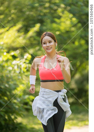 beautiful woman running in the park 105560466