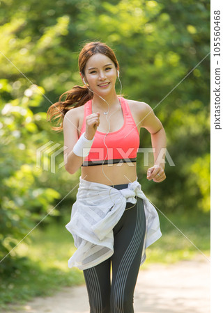 beautiful woman running in the park 105560468