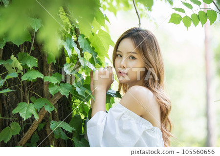 a beautiful woman in the forest 105560656