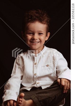 happy child boy preschooler smiling sitting on chair 105561118