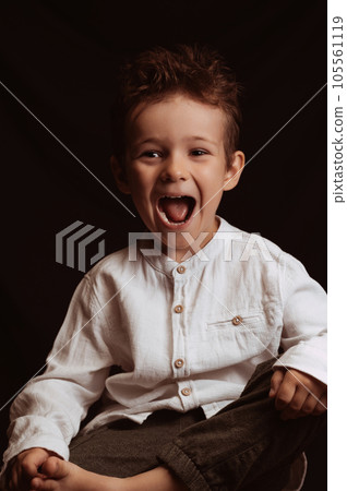 preschool child boy screams while sitting on chair 105561119