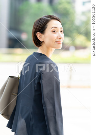 A woman in a suit looking back 105561120