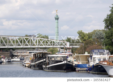 The port of Arsenal, which connects the Canal Saint-Martin with the river Seine. View of the July Revolution column on Place de la Bastille. The port of Arsenal, which connects the Canal Saint-Martin with the river Seine. View of the July Revolution column on Place de la Bastille. 105561427