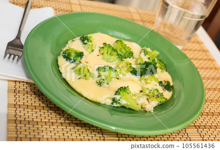 Wholesome breakfast. omelet with broccoli on green plate 105561436