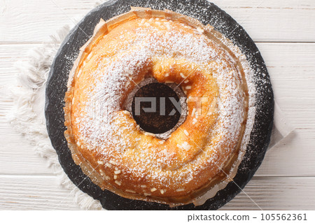 Ciambella cake is a traditional Italian breakfast treat closeup. Horizontal top view Ciambella cake is a traditional Italian breakfast treat closeup. Horizontal top view 105562361