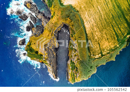Atlantic Ocean surf, rocky coastline and farmlands of Ponta Delgada 105562542