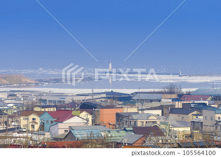 Nemuro Port and surrounding townscape with drift ice / Nemuro, Japan 105564100