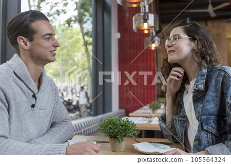 Couple Meeting In Busy Cafe Restaurant 105564324