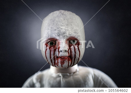 Creepy bloody doll over dark misty background 105564602