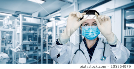 A laboratory assistant looks at a prototype . A laboratory assistant looks at a prototype . 105564979