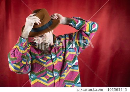 Vintage Hipster man with hat and mustache posing confident with colored t-shirt 105565343