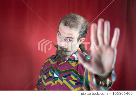 Hipster man with mustache saying No or Stop and looking at camera with open hand Hipster man with mustache saying No or Stop and looking at camera with open hand 105565403