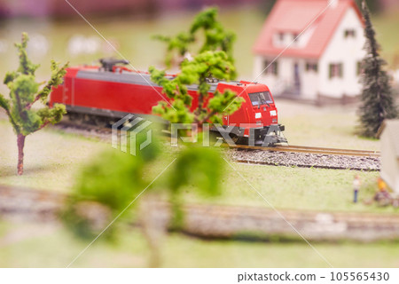 Set of red electric train model and layout with whole scene with trees and house Set of red electric train model and layout with whole scene with trees and house 105565430