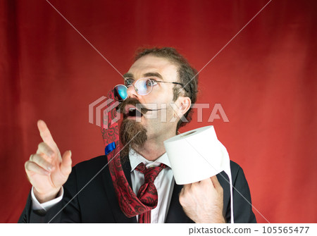 Funny man with glasses, red tie on his head and toilet paper in hand looking up Funny man with glasses, red tie on his head and toilet paper in hand looking up 105565477