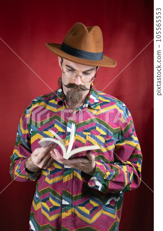 Vintage Hipster man with glasses, hat and mustache watching a book 105565553