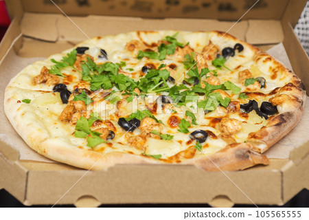 Pizza in a cardboard box for delivery. Pizza in delivery box with open lid Pizza in a cardboard box for delivery. Pizza in delivery box with open lid 105565555