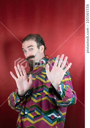 Hipster man with mustache saying No or Stop looking at camera with open hands Hipster man with mustache saying No or Stop looking at camera with open hands 105565556