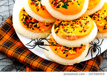 Sugar cookies with orange icing and spkinkles. Sugar cookies with orange icing and spkinkles. 105566959