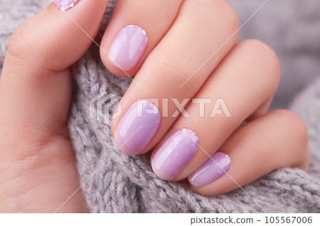 Womans hand with fashionable lavender manicure. Winter christmas nail design 105567006