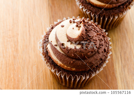 Gourmet chocolate caramel swirl cupcake with chocolate sprikles. 105567116