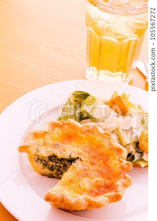Individual spinach quiche served with salad. 105567272