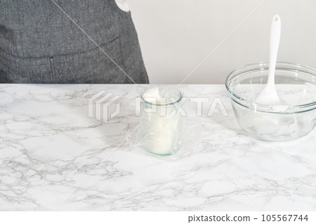 Transferring homemade royal icing into the piping bags for decorating sugar cookies. Transferring homemade royal icing into the piping bags for decorating sugar cookies. 105567744